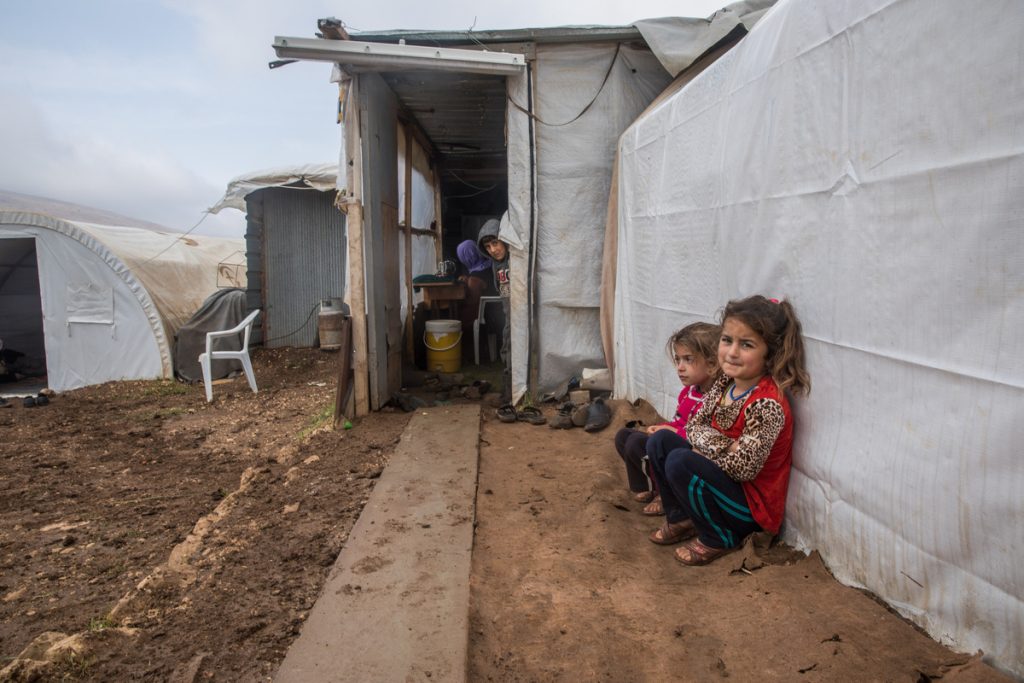 Pictur eof two girls sitting in a Yazidi Camp