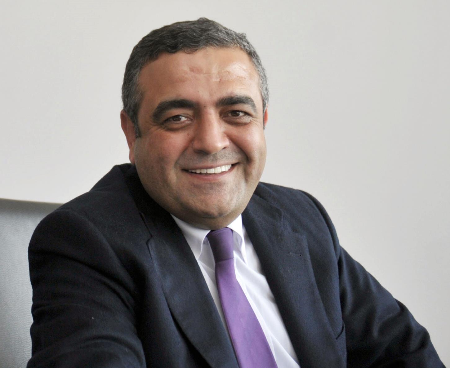 Photo of Sezgin Tanrıkulu wearing a black suit