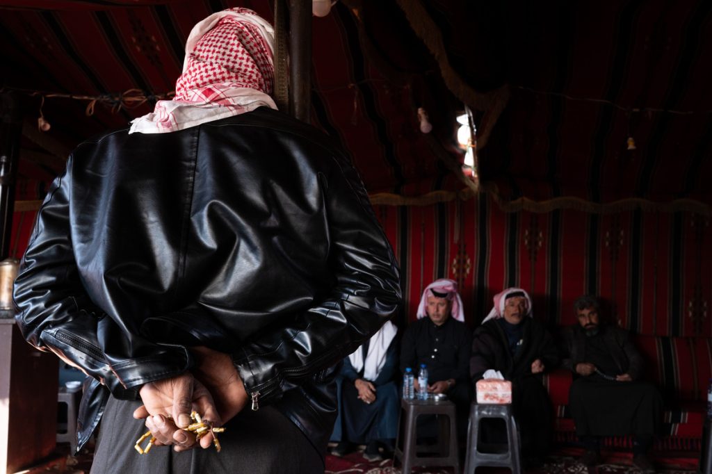 A member of the Bani Khaled tribe stands before Sheikh Faisal al-Basha during the condolences offered to the family of Abdullah Al-Aboud, who was killed along with his partner in Homs.
